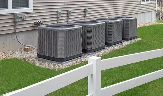Air Source Heat Pump Installation Essex and Suffolk - a row of heat pump installed outside a home