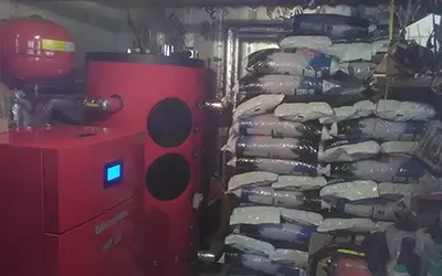 view of a biomass boiler with bags of pellet as fuel